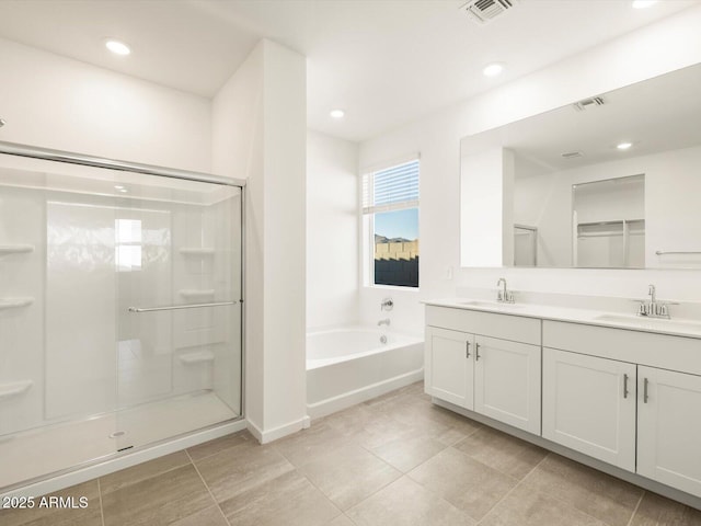 bathroom featuring tile patterned floors, vanity, and plus walk in shower