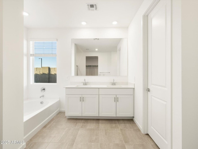 bathroom with a bath and vanity