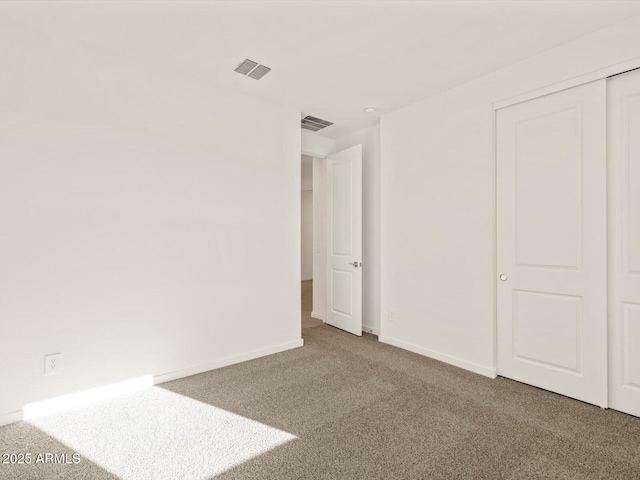 unfurnished bedroom featuring a closet and carpet flooring