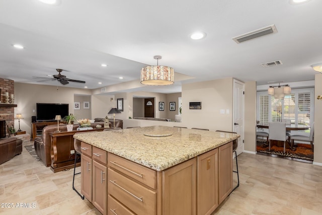 410 E Beck Ln, Phoenix, AZ 85022 - kitchen with a breakfast bar, open floor plan, a kitchen island, a ceiling fan, and recessed lighting