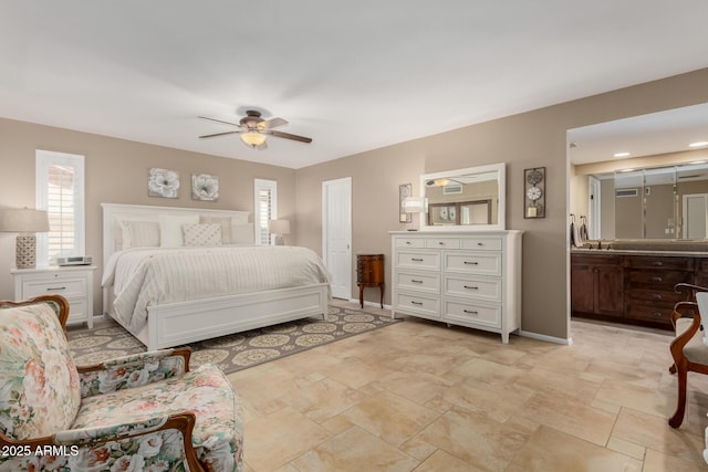 410 E Beck Ln, Phoenix, AZ 85022 - bedroom with light stone finish flooring, baseboards, connected bathroom, and ceiling fan