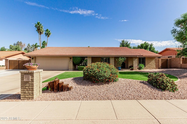 410 E Beck Ln, Phoenix, AZ 85022 - ranch-style home with a tile roof, a garage, concrete driveway, fence, and brick siding