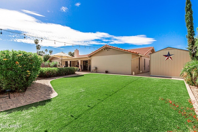410 E Beck Ln, Phoenix, AZ 85022 - view of grassy yard featuring an outbuilding and a storage shed