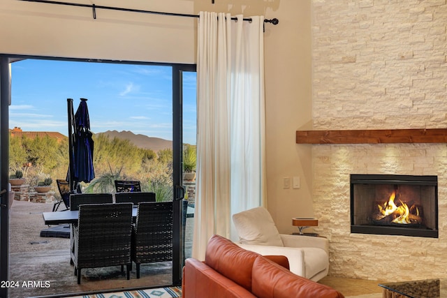 sitting room featuring a mountain view and a fireplace