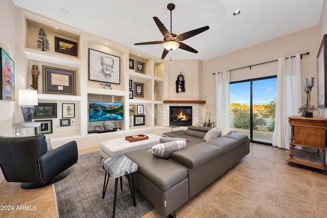 tiled living room featuring built in shelves and ceiling fan