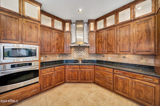 28217 N 139th St, Scottsdale, AZ 85262 - kitchen featuring appliances with stainless steel finishes, wall chimney range hood, decorative backsplash, brown cabinets, and recessed lighting