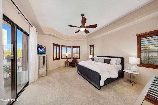 carpeted bedroom featuring access to exterior, multiple windows, and ceiling fan