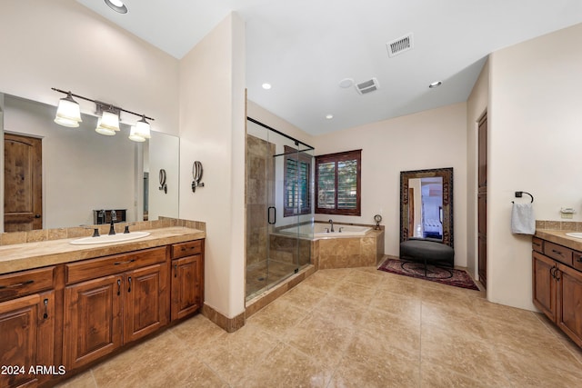 bathroom featuring vanity, independent shower and bath, and tile patterned flooring