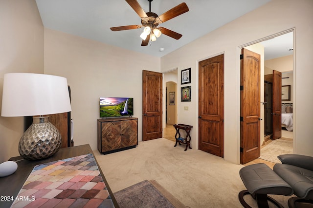 interior space featuring light carpet and ceiling fan