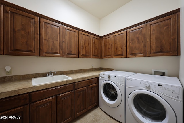 laundry area with sink, independent washer and dryer, and cabinets