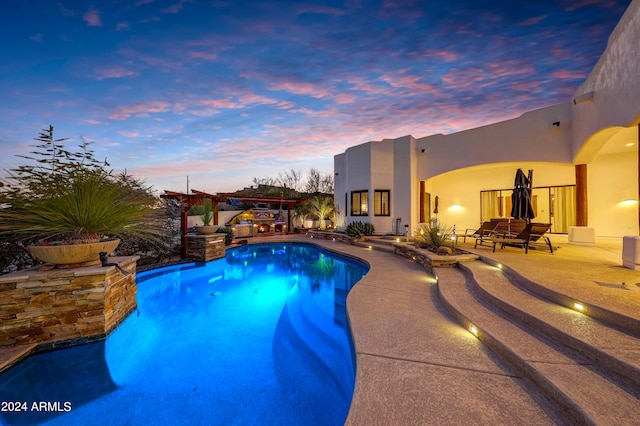 pool at dusk featuring a patio