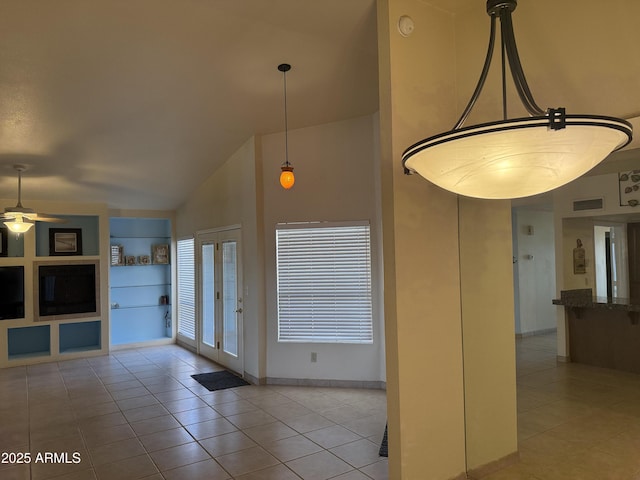 interior space with visible vents, baseboards, high vaulted ceiling, and a ceiling fan