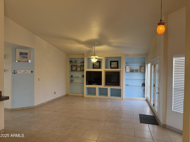 unfurnished living room with vaulted ceiling, light tile patterned flooring, a ceiling fan, and built in features