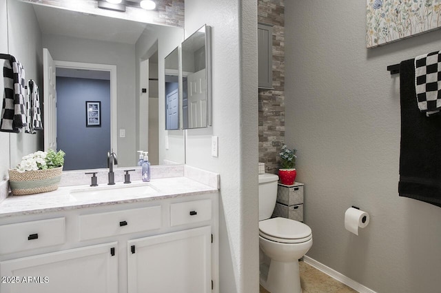 half bathroom featuring vanity and toilet