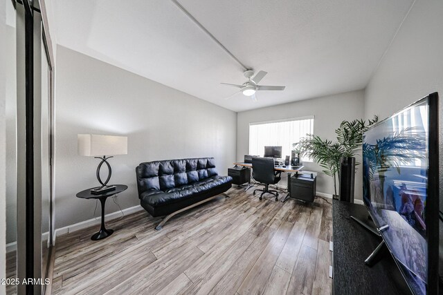 office featuring baseboards, wood finished floors, and a ceiling fan