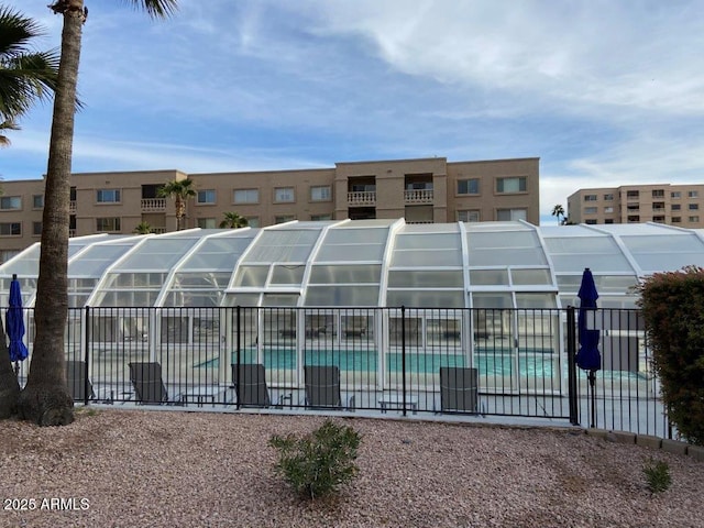 view of pool with a fenced in pool and fence