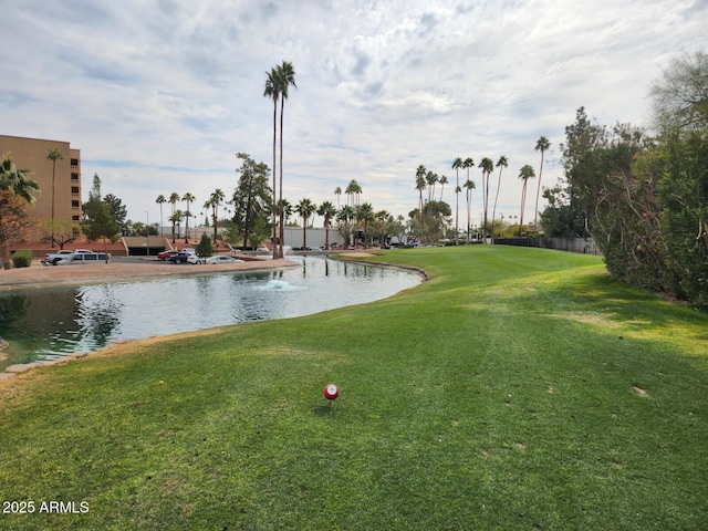 view of community with a lawn and a water view