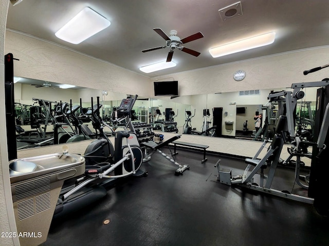 gym with visible vents, lofted ceiling, ceiling fan, and a textured wall