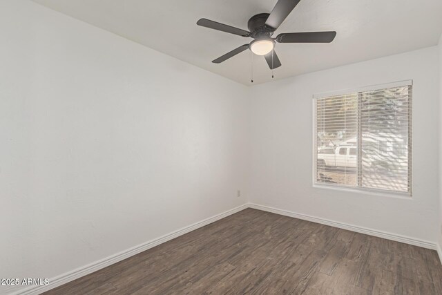 empty room featuring dark hardwood / wood-style floors and ceiling fan