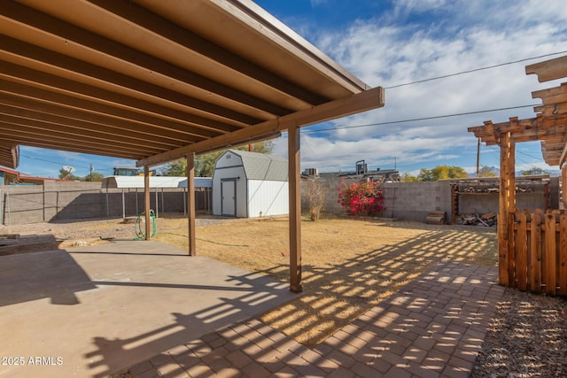 view of patio featuring a storage shed