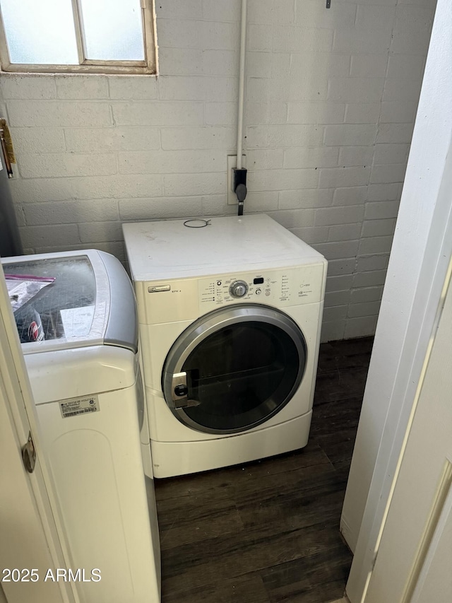 laundry room featuring dark hardwood / wood-style floors and washer and clothes dryer