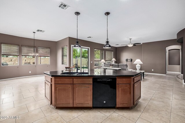 kitchen with a sink, dark countertops, ceiling fan, black dishwasher, and visible vents