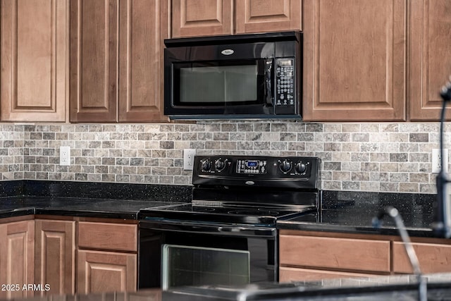 kitchen with dark countertops, tasteful backsplash, and black appliances