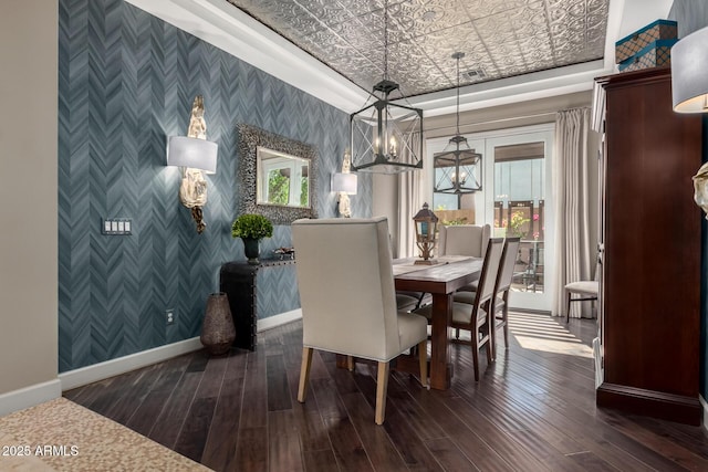 17673 E Bronco Dr, Queen Creek, AZ 85142 - dining area featuring wallpapered walls, dark wood-style floors, an accent wall, baseboards, and a chandelier