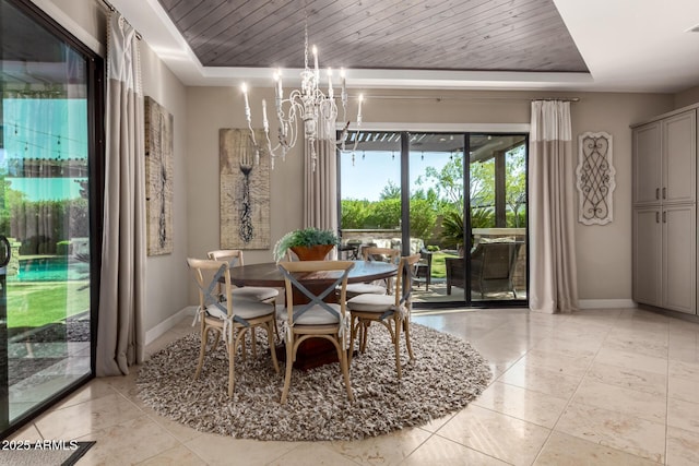 17673 E Bronco Dr, Queen Creek, AZ 85142 - dining room featuring light tile patterned floors, an inviting chandelier, a tray ceiling, and baseboards
