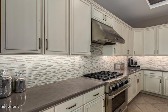 17673 E Bronco Dr, Queen Creek, AZ 85142 - kitchen featuring under cabinet range hood, dark countertops, decorative backsplash, stainless steel range, and light tile patterned floors