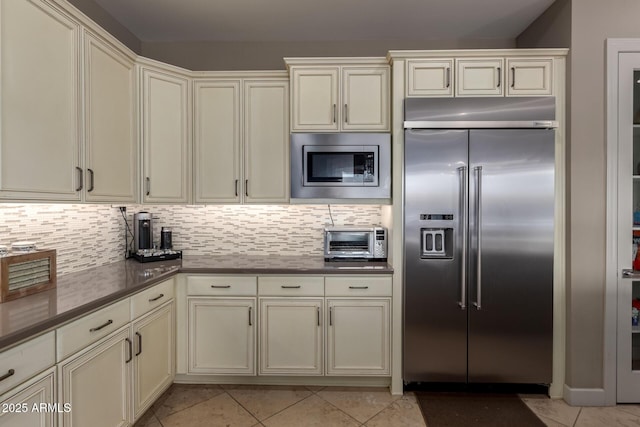 17673 E Bronco Dr, Queen Creek, AZ 85142 - kitchen with built in appliances, cream cabinets, a toaster, and light tile patterned floors