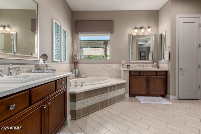17673 E Bronco Dr, Queen Creek, AZ 85142 - bathroom featuring two vanities, wood finished floors, a garden tub, and a sink