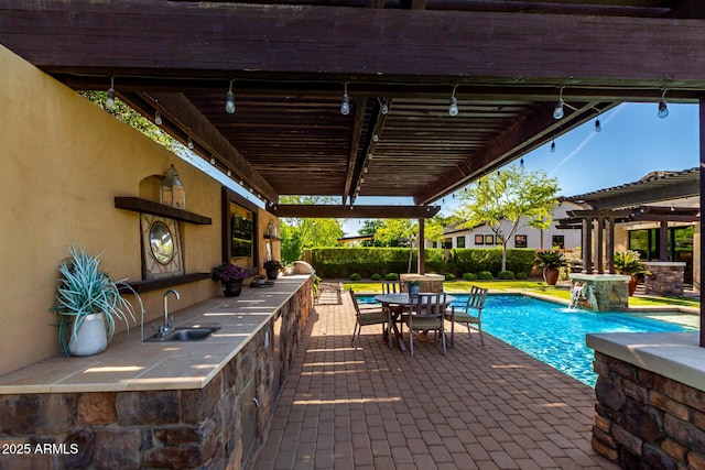 17673 E Bronco Dr, Queen Creek, AZ 85142 - view of patio / terrace with a pergola, outdoor dining space, a sink, a fenced in pool, and area for grilling