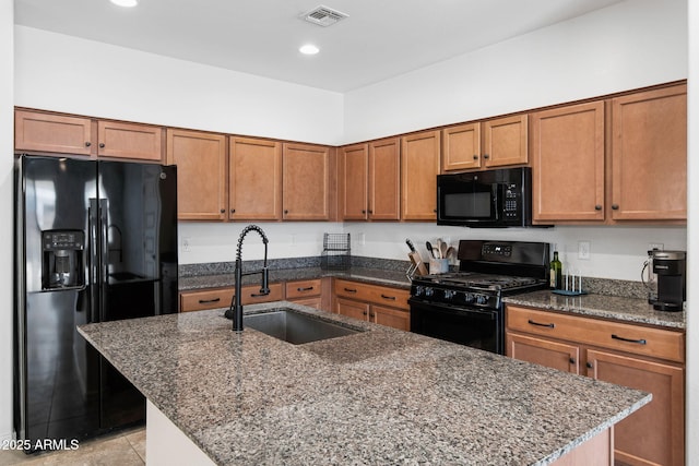 5429 W Chuck Box Rd, Laveen, AZ 85339 - kitchen featuring black appliances, a sink, brown cabinets, an island with sink, and recessed lighting