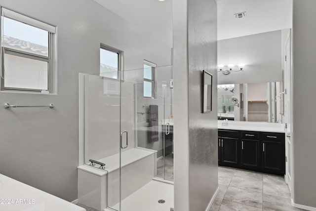 full bath with vanity, visible vents, a wealth of natural light, and a shower stall