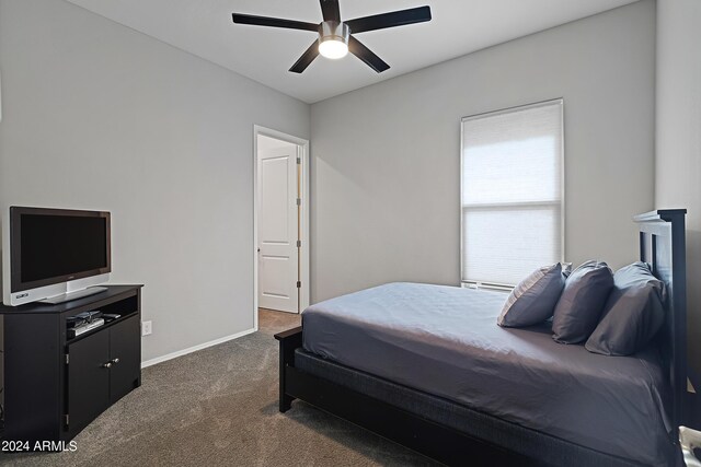 bedroom with baseboards, ceiling fan, and dark carpet