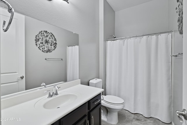 bathroom with vanity, curtained shower, and toilet