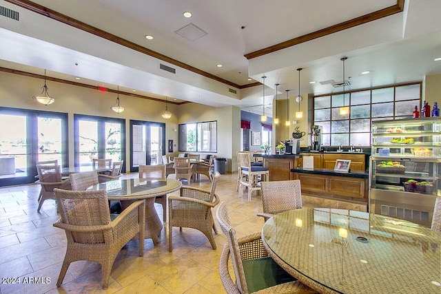 dining area with ornamental molding and light tile patterned flooring