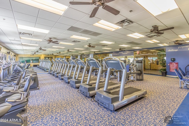 workout area featuring visible vents, a paneled ceiling, and ceiling fan
