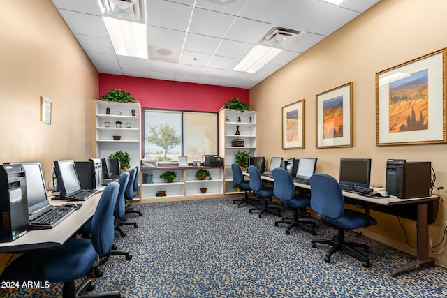 carpeted home office featuring visible vents and a drop ceiling