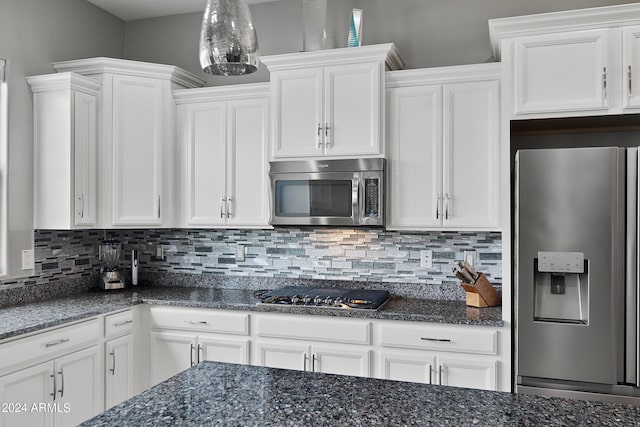 kitchen with appliances with stainless steel finishes, backsplash, and white cabinetry