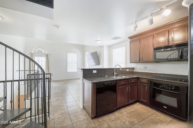 5749 S 21st Ter, Phoenix, AZ 85040 - kitchen featuring black appliances, a sink, plenty of natural light, and dark stone counters