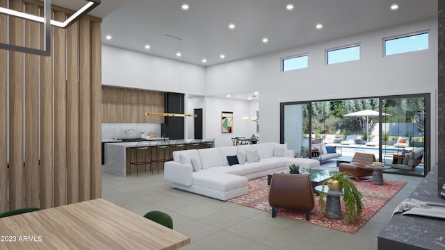 living room with a towering ceiling and plenty of natural light