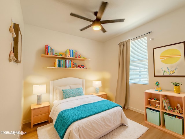 bedroom with ceiling fan and light hardwood / wood-style floors