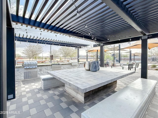 view of patio / terrace with area for grilling, a water view, and a pergola