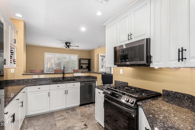 kitchen featuring gas stove, a sink, white cabinets, dishwasher, and stainless steel microwave