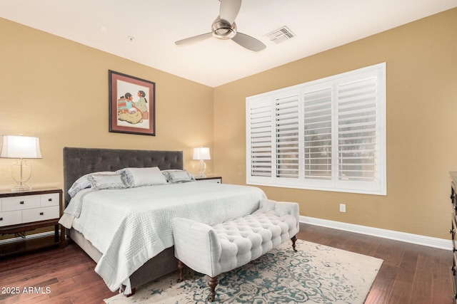 bedroom featuring visible vents, baseboards, wood finished floors, and a ceiling fan