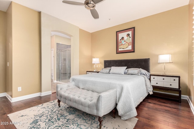 bedroom with ceiling fan, baseboards, arched walkways, and wood finished floors