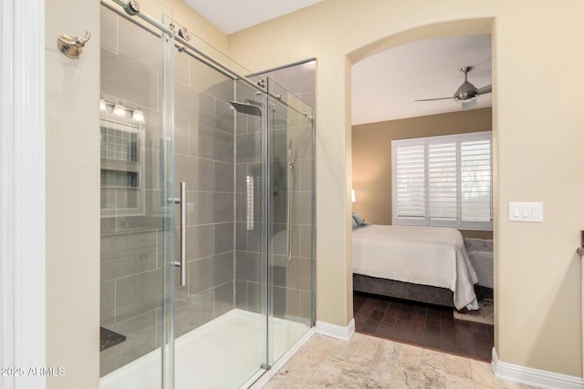 bathroom with baseboards, a stall shower, ensuite bathroom, and ceiling fan