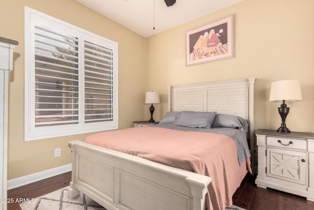 bedroom featuring dark wood-type flooring and baseboards